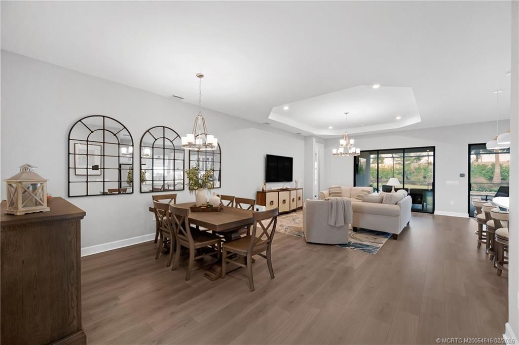 15111 Pescara Street Naples, FL 34114 - Photo 6 of 43 a view of a dining room with furniture window and wooden floor