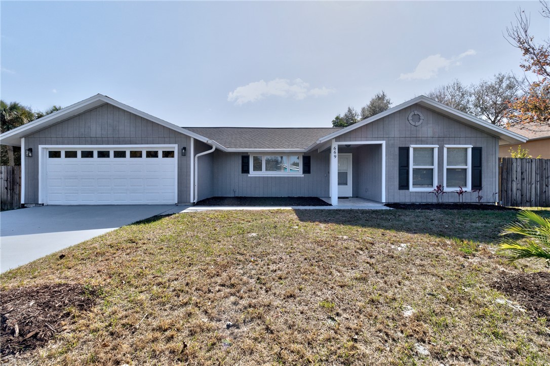 669 Vocelle Avenue Sebastian, FL 32958 - Photo 1 of 34 a front view of a house with a yard