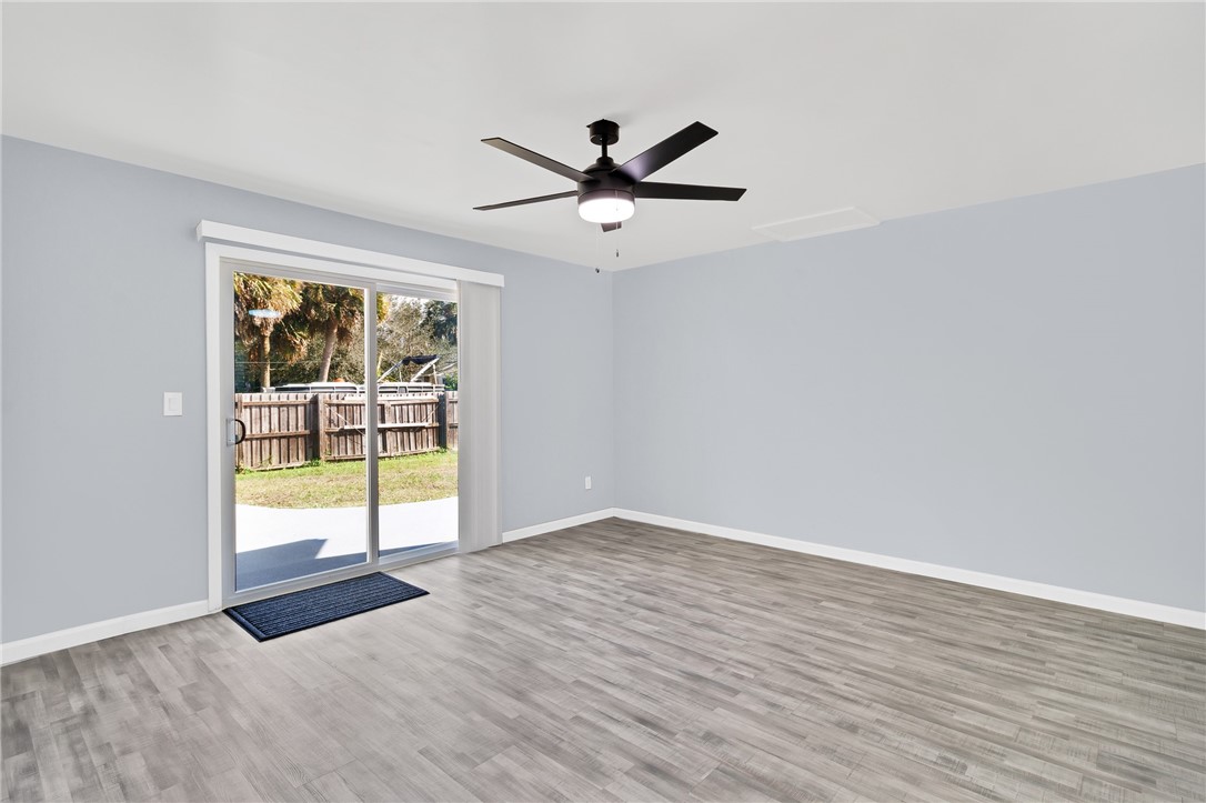 669 Vocelle Avenue Sebastian, FL 32958 - Photo 12 of 34 wooden floor in an empty room with a window