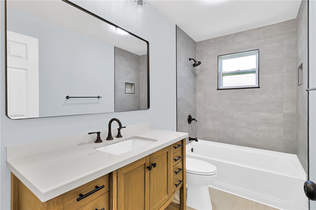669 Vocelle Avenue Sebastian, FL 32958 - Photo 19 of 34 a bathroom with a sink a toilet a mirror and shower