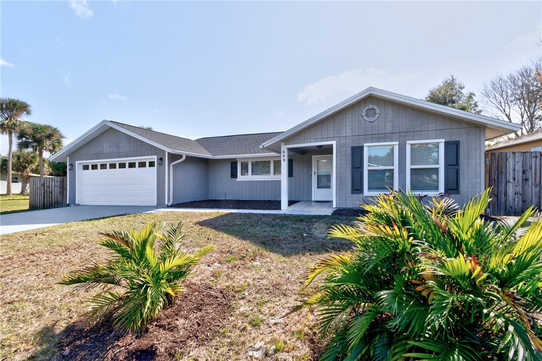 669 Vocelle Avenue Sebastian, FL 32958 - Photo 2 of 34 a front view of a house with a garden