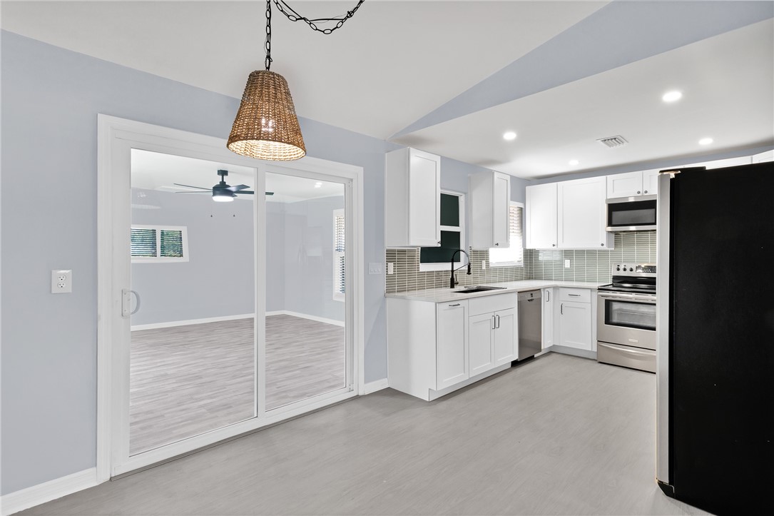 669 Vocelle Avenue Sebastian, FL 32958 - Photo 7 of 34 a kitchen with white cabinets and refrigerator