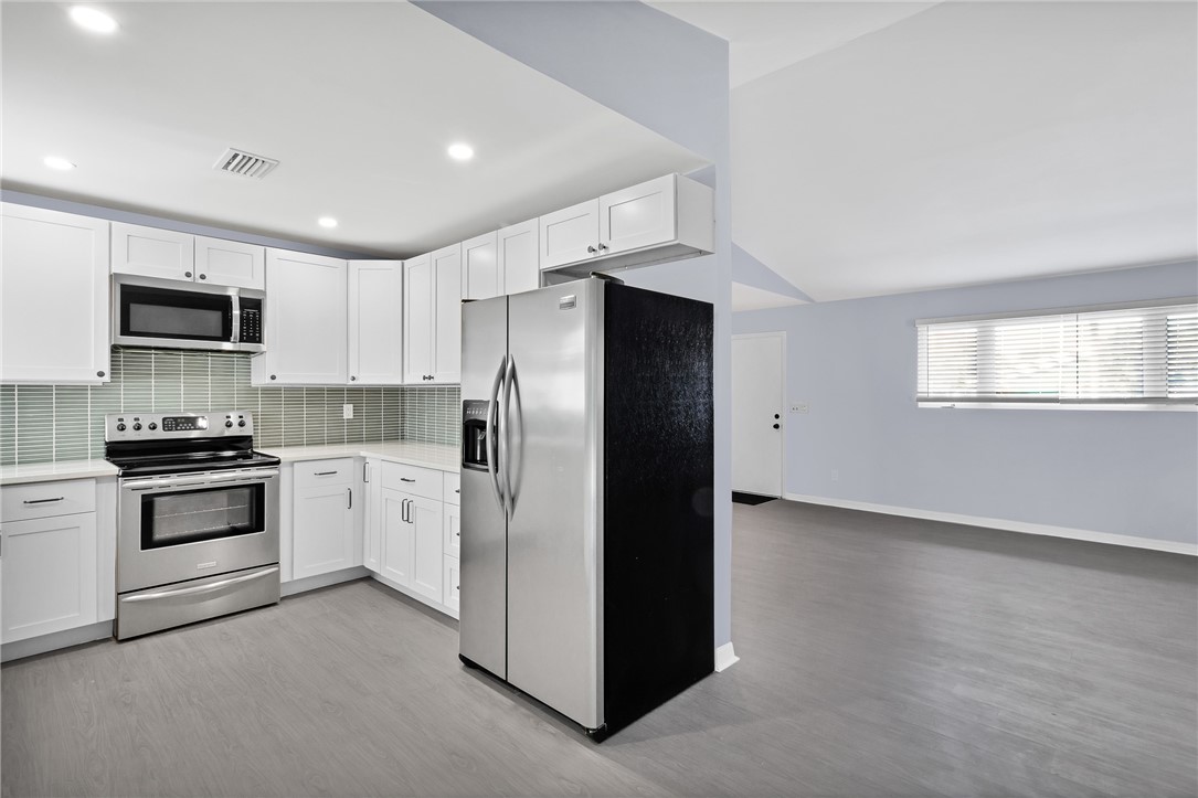 669 Vocelle Avenue Sebastian, FL 32958 - Photo 9 of 34 a kitchen with stainless steel appliances a refrigerator stove and microwave