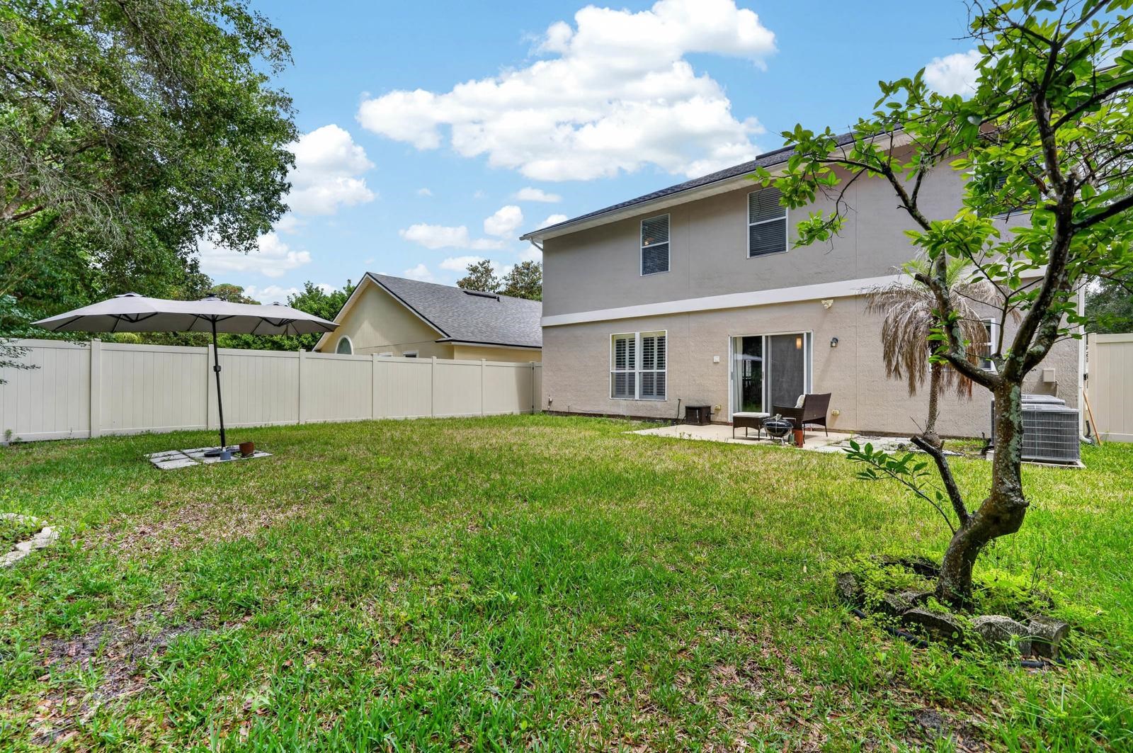 1237 Splendid Ravine Street St. Augustine, FL 32092 - Photo 35 of 62 a view of a house with backyard and garden