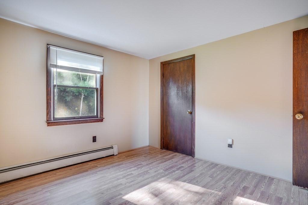 81 Burns Road Pelham, NH 03076 - Photo 24 of 39 a view of an empty room with window and wooden floor