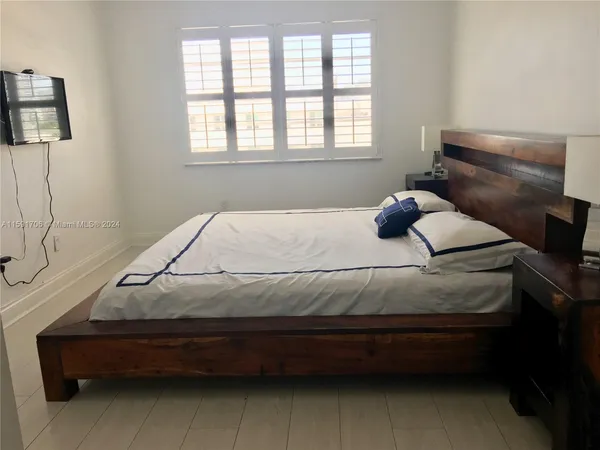 a bedroom with a bed and window