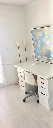 a white chair sitting next to a white bench
