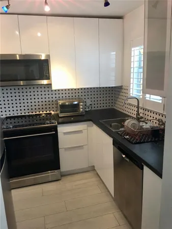 a kitchen with a sink stove and microwave