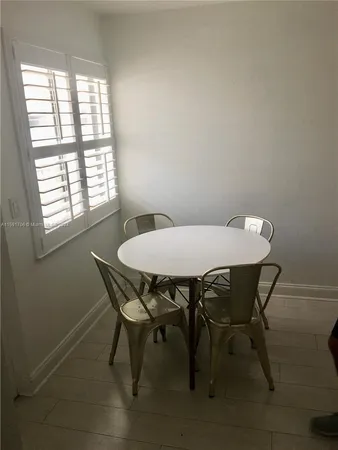 a view of a dining room with furniture and window