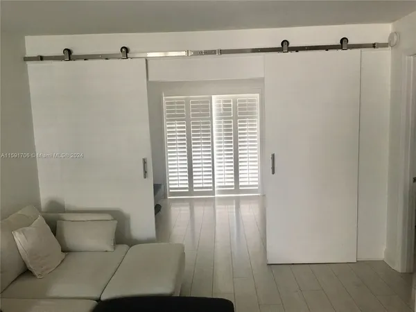 a bathroom with a window and a shower