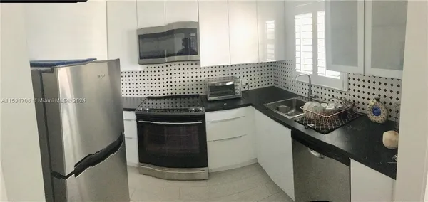 a kitchen with a stove and a refrigerator