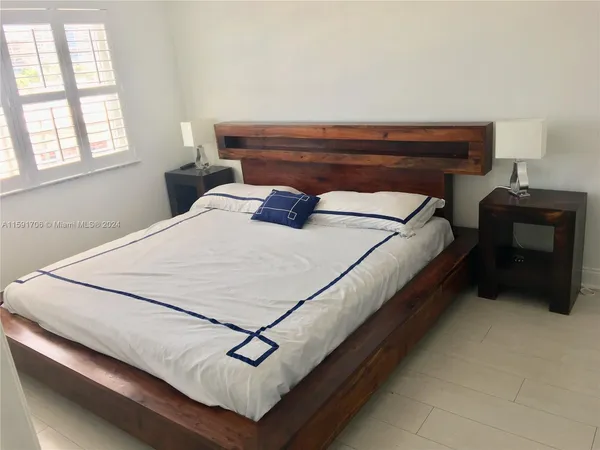 a bedroom with bed and window
