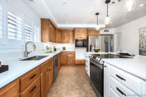 a kitchen with stainless steel appliances a sink stove and cabinets