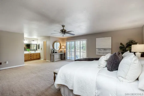 a bedroom with a large bed and a chandelier