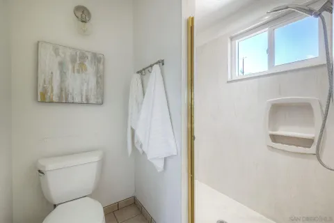 a white toilet sitting next to a bathroom sink