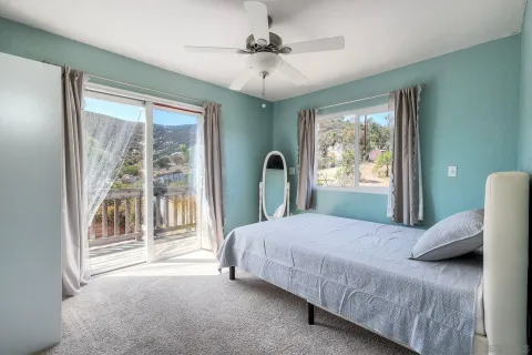a bedroom with a large bed and a large window