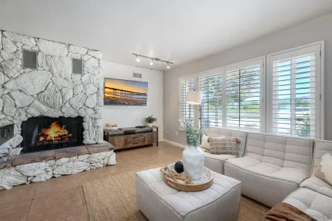 a living room with furniture and a fireplace