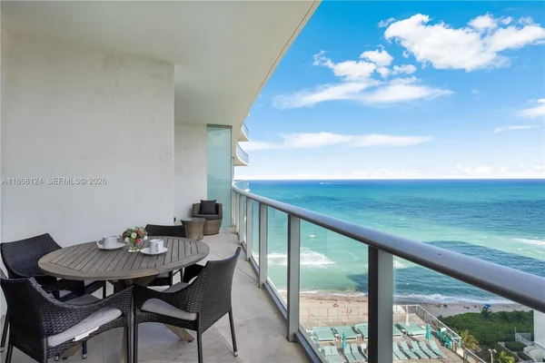 a view of a balcony dining table and chairs