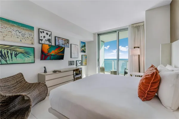 a bedroom with furniture and a flat screen tv