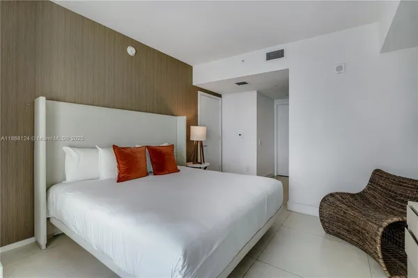 a bedroom with a bed and a couch