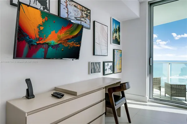 a view of a workspace with furniture and screen tv