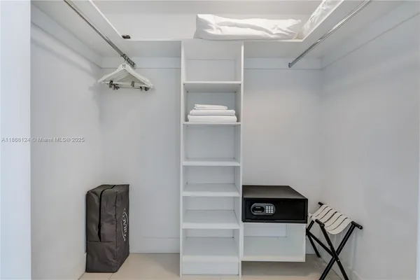 a view of walk in closet with empty racks