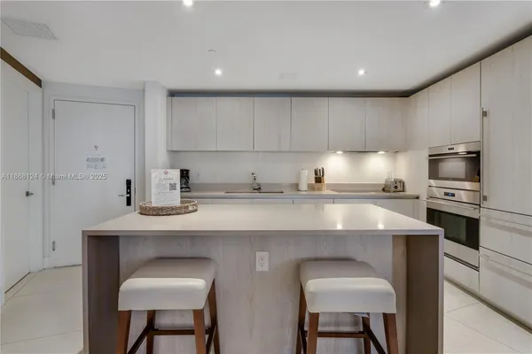 a kitchen with stainless steel appliances a sink stove and cabinets