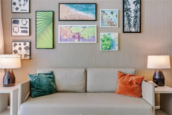 a living room with couch and painting on the wall