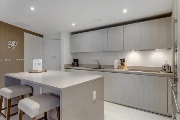 a kitchen with a sink cabinets and wooden floor
