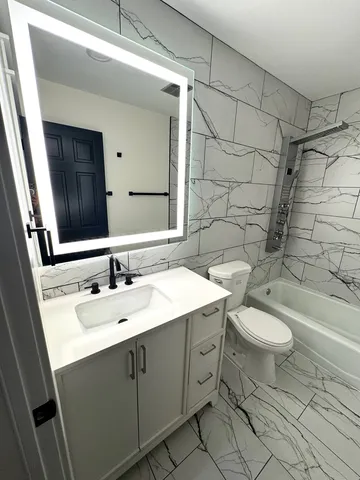 a bathroom with a sink toilet and shower