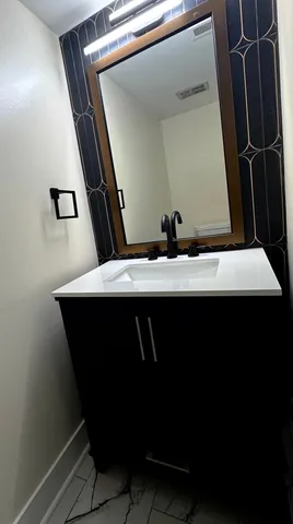 an empty room with closet and a chandelier fan