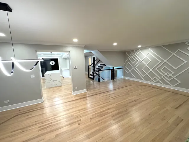 a view of a living room and kitchen with furniture and wooden floor