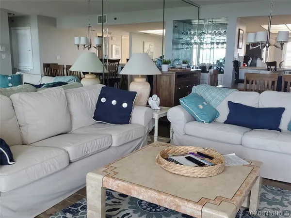 a living room with furniture and a chandelier