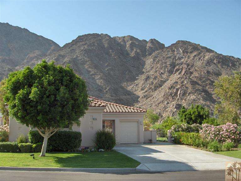 54255 Riviera La Quinta, CA 92253 - Photo 1 of 8 a view of a house with a yard and a large tree