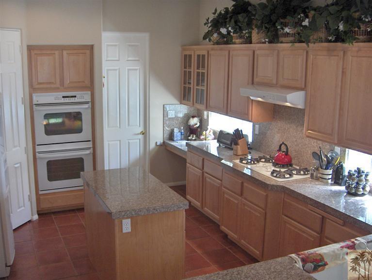 54255 Riviera La Quinta, CA 92253 - Photo 3 of 8 a kitchen with kitchen island granite countertop a stove a sink and dishwasher
