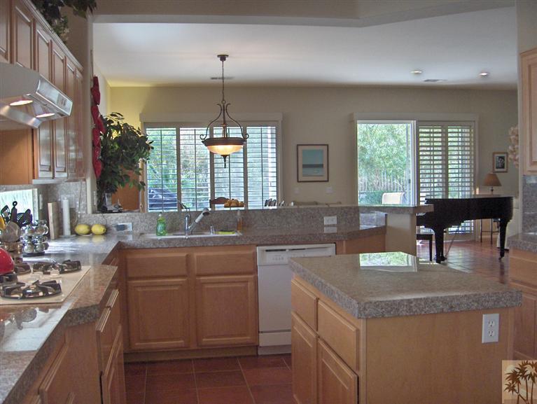54255 Riviera La Quinta, CA 92253 - Photo 5 of 8 a kitchen with center island table and chairs