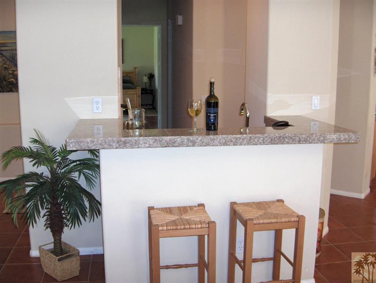54255 Riviera La Quinta, CA 92253 - Photo 6 of 8 a bathroom with a granite countertop sink and a mirror