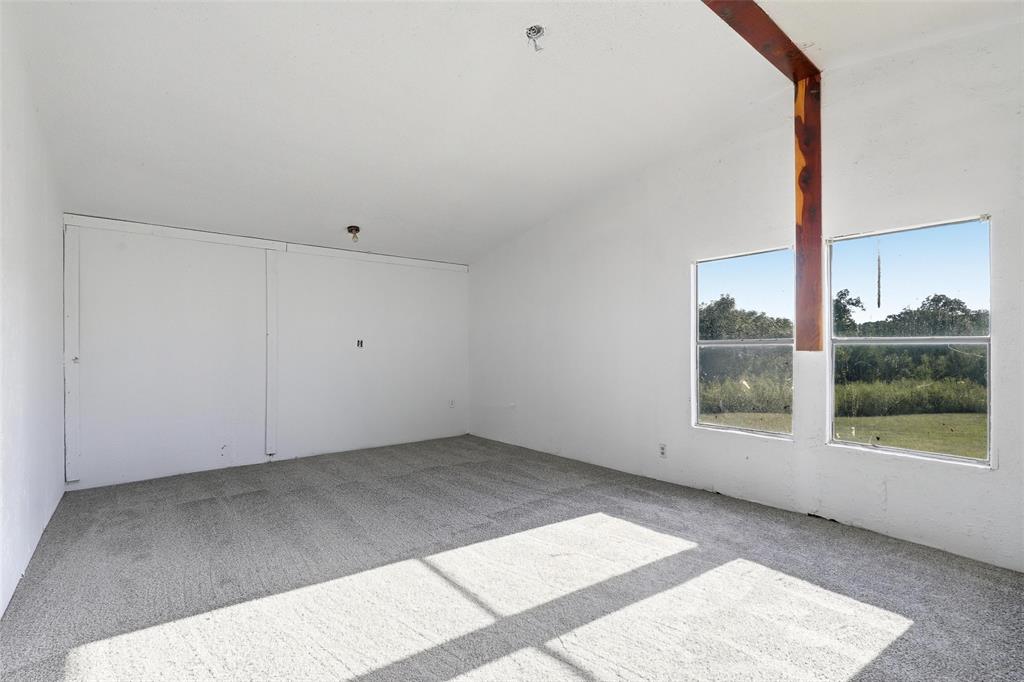 1491 County Road 319, Unit B Cleburne, TX 76033 - Photo 12 of 24 an empty room with a window