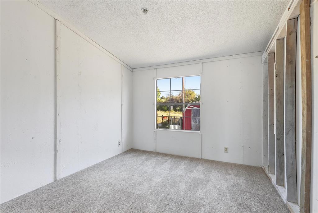 1491 County Road 319, Unit B Cleburne, TX 76033 - Photo 17 of 24 an empty room with windows