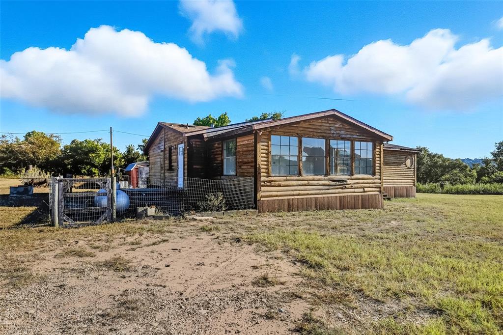 1491 County Road 319, Unit B Cleburne, TX 76033 - Photo 18 of 24 a front view of a house with garden