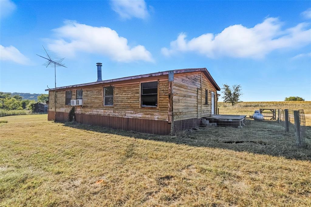 1491 County Road 319, Unit B Cleburne, TX 76033 - Photo 19 of 24 a view of a backyard of the house