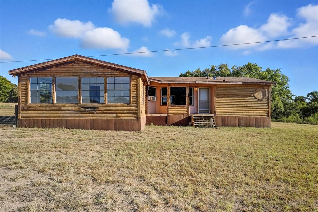 1491 County Road 319, Unit B Cleburne, TX 76033 - Photo 2 of 24 a front view of a house with a yard