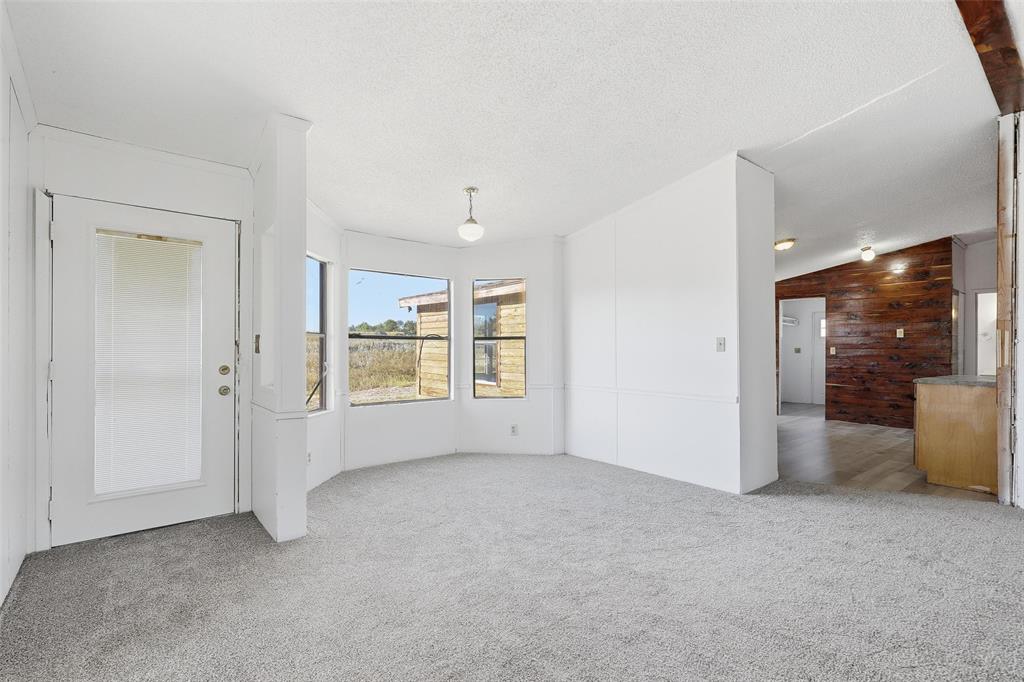 1491 County Road 319, Unit B Cleburne, TX 76033 - Photo 7 of 24 a view of an empty room with a window