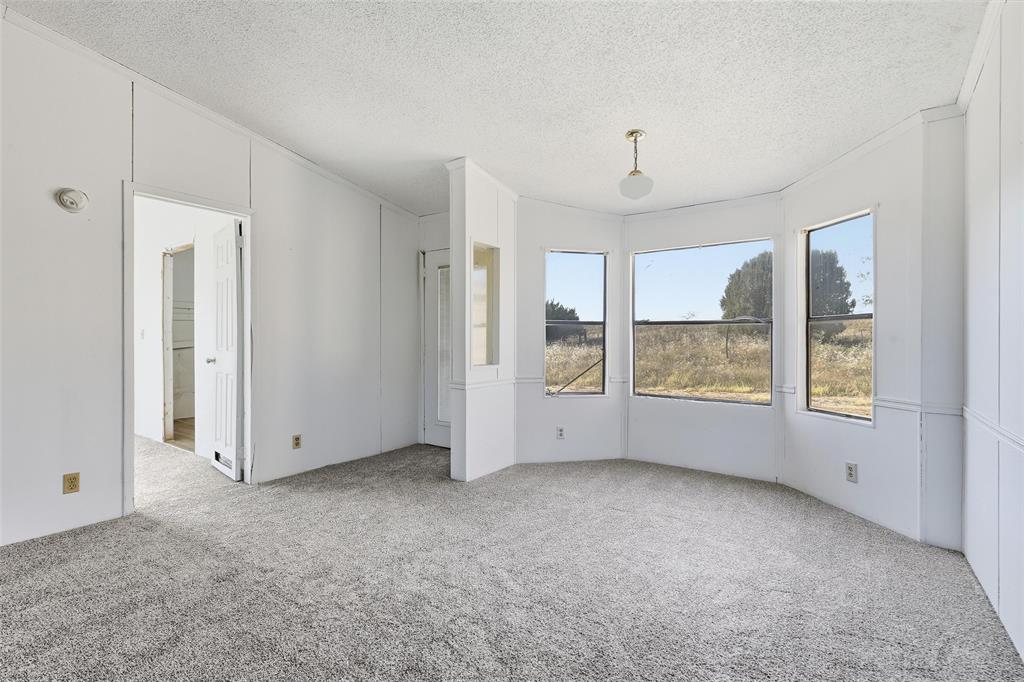 1491 County Road 319, Unit B Cleburne, TX 76033 - Photo 8 of 24 a view of an empty room with a window