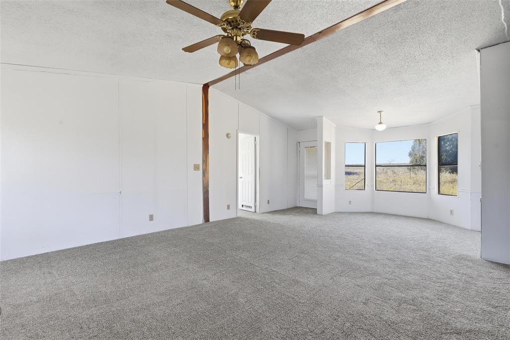 1491 County Road 319, Unit B Cleburne, TX 76033 - Photo 9 of 24 a view of an empty room with a window