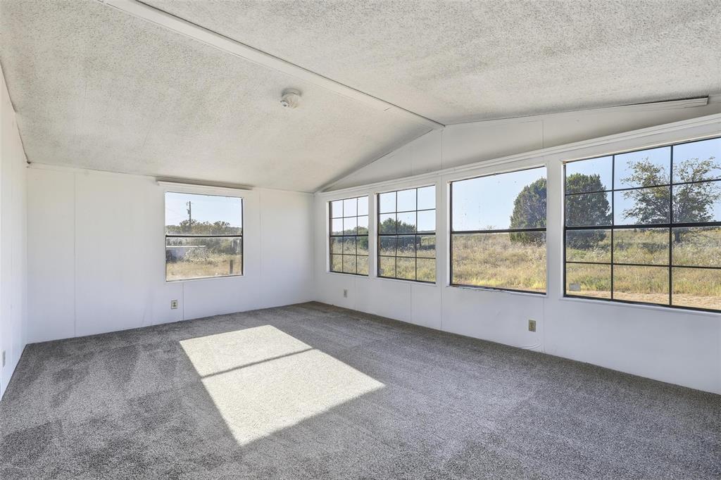 1491 County Road 319, Unit B Cleburne, TX 76033 - Photo 10 of 24 an empty room with windows