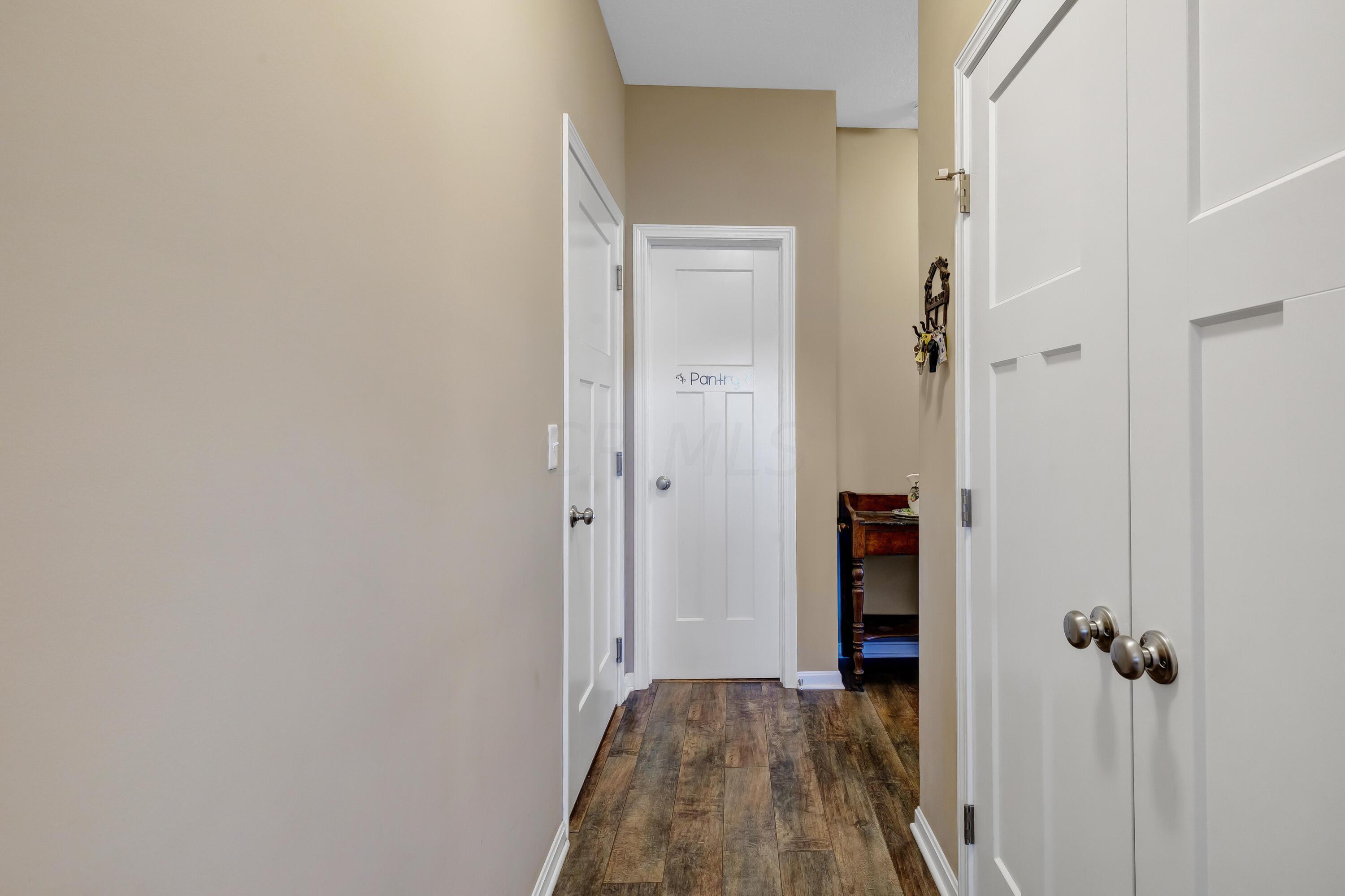 16347 Murphy Road Sunbury, OH 43074 - Photo 20 of 74 • Laminate flooring • Tan painted walls • Closet with french doors