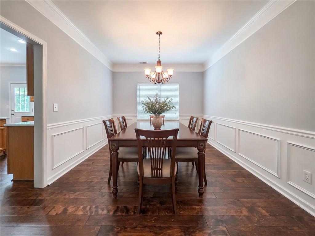 43 Ivy Mist Lane Acworth, GA 30101 - Photo 5 of 58 a dining room with furniture a chandelier and wooden floor