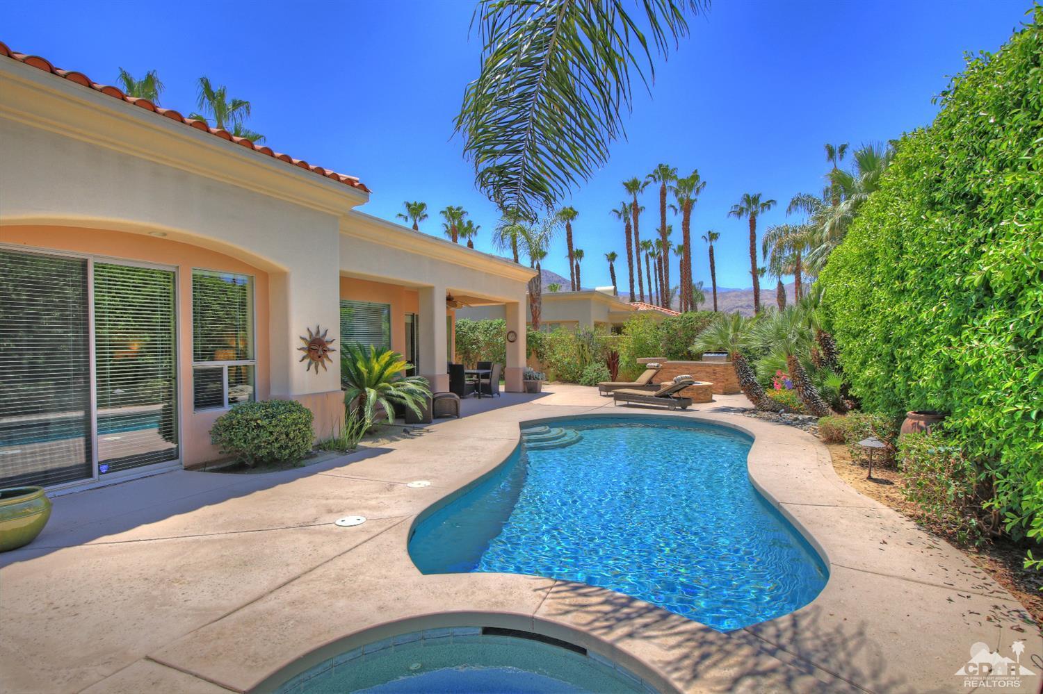 a swimming pool with outdoor seating and yard