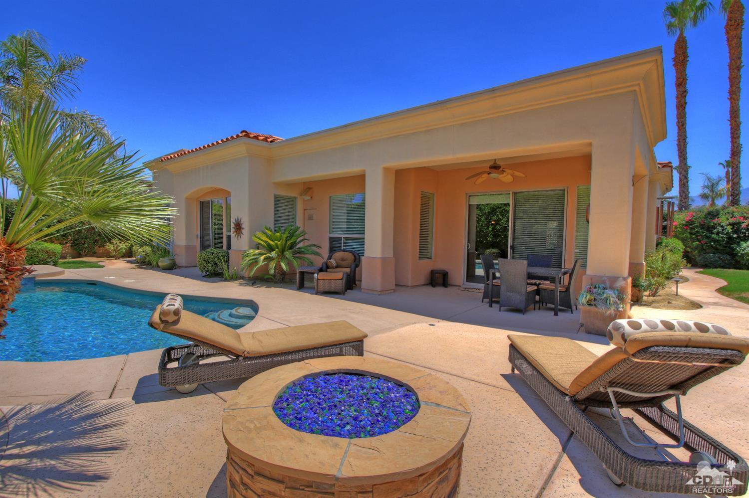 4 Mesquite Ridge Lane Rancho Mirage, CA 92270 - Photo 2 of 62 a view of a backyard with swimming pool table and chairs